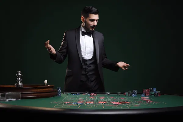 LINEBED Mobile App — Your complete hub for casino and sports A man focused on his laptop with live stats in the background, highlighting the dedicated sports and gaming features of the LINEBED mobile app.