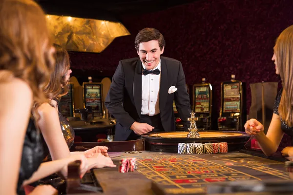 A stylish woman beside vibrant slot machines displaying glowing sevens, showcasing the variety of top slots at LINEBED.