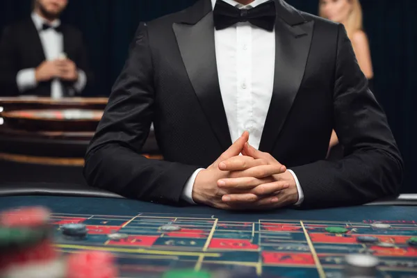 LINEBED — A high-class gaming experience without limits A woman in a luxurious green gown next to an ornate roulette wheel, capturing the upscale casino mood of LINEBED.