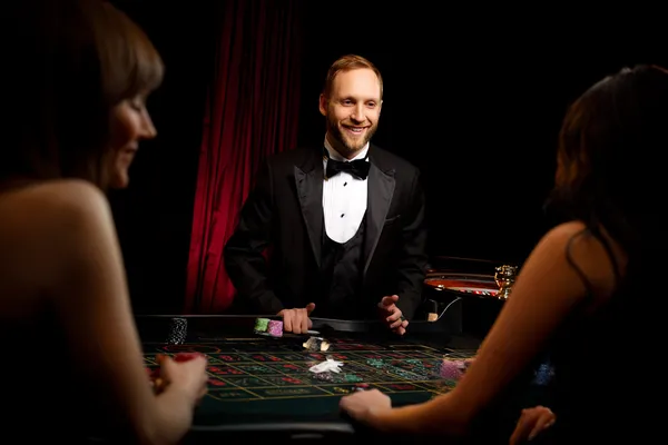 LINEBED Mobile Casino — Play anytime, anywhere A player using their smartphone during a festive local event, representing LINEBED’s fully mobile-friendly casino.